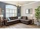 Cozy living room with large window, sectional sofa, stylish lighting, and wood-look floors at 3732 Fallscrest Cir, Clermont, FL 34711