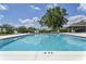 Community swimming pool with clear blue water and a 6-foot depth marking, surrounded by lounge chairs at 3732 Fallscrest Cir, Clermont, FL 34711