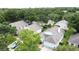 Aerial view of neighborhood featuring lush green trees and manicured lawns at 3821 Doune Way, Clermont, FL 34711