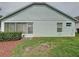 View of the back of the house with a well maintained lawn and minimal landscaping at 3821 Doune Way, Clermont, FL 34711