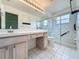 Bathroom with a tile floor, dual vanity and glass door shower at 3821 Doune Way, Clermont, FL 34711