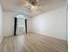 Bright, empty bedroom features a ceiling fan and a large window with plenty of natural light at 3821 Doune Way, Clermont, FL 34711