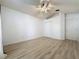 Vacant room showcasing laminate flooring, white walls and ceiling fan at 3821 Doune Way, Clermont, FL 34711