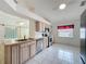 Kitchen features a stainless steel dishwasher and range, with a double bowl sink and tile flooring at 3821 Doune Way, Clermont, FL 34711