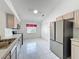 Spacious kitchen featuring stainless steel appliances, ample counter space, and white tile flooring at 3821 Doune Way, Clermont, FL 34711