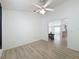 Open living space with ceiling fan, view into dining area and kitchen, and neutral walls at 3821 Doune Way, Clermont, FL 34711
