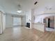 Bright living room featuring a fireplace, ceiling fan and wood laminate flooring at 3821 Doune Way, Clermont, FL 34711