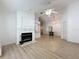 Open-concept living area with a fireplace and sleek wood laminate flooring at 3821 Doune Way, Clermont, FL 34711
