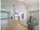 Open-concept living space with a fireplace, dining area, and kitchen featuring modern appliances and light-filled interior at 3821 Doune Way, Clermont, FL 34711