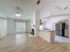 Open living space with fireplace and view into kitchen and dining area, with ceiling fan and lots of light at 3821 Doune Way, Clermont, FL 34711