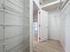 Walk-in closet with installed shelving, light laminate flooring and adjacent room access at 3821 Doune Way, Clermont, FL 34711