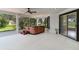 Relaxing screened-in porch featuring a hot tub and sliding glass doors at 39634 Harbor Hills Blvd, Lady Lake, FL 32159