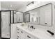 Bathroom featuring a shower and vanity with quartz countertops, undermount sink and black hardware at 39634 Harbor Hills Blvd, Lady Lake, FL 32159