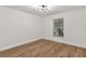 Bedroom with neutral walls, hardwood flooring, and a window bringing in natural light at 39634 Harbor Hills Blvd, Lady Lake, FL 32159