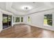 Spacious bedroom with tray ceiling, large windows, and sliding glass door access at 39634 Harbor Hills Blvd, Lady Lake, FL 32159