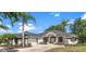 Charming single-story home featuring manicured landscaping, fresh exterior paint and a two-car garage at 39634 Harbor Hills Blvd, Lady Lake, FL 32159