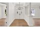 A grand foyer featuring wood-look floors, a decorative chandelier and fresh paint at 39634 Harbor Hills Blvd, Lady Lake, FL 32159