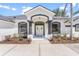 A close-up of the front of the home featuring fresh paint, landscaping and a welcoming entrance at 39634 Harbor Hills Blvd, Lady Lake, FL 32159