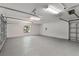 Spacious two-car garage with updated gray floors and ample lighting at 39634 Harbor Hills Blvd, Lady Lake, FL 32159