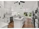 This bright kitchen features a central island, stainless steel appliances, and wood-look flooring at 39634 Harbor Hills Blvd, Lady Lake, FL 32159