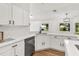 A well-lit kitchen features white cabinets, modern hardware, and quartz countertops at 39634 Harbor Hills Blvd, Lady Lake, FL 32159