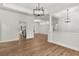 A spacious living room has an open floor plan with wood-look floors and modern lighting at 39634 Harbor Hills Blvd, Lady Lake, FL 32159