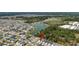 Neighborhood aerial view showing the community, surrounded by trees and a pond at 3984 Kanawha Pl, The Villages, FL 32163