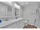 Bright bathroom features a double sink vanity with marble countertops and modern fixtures at 3984 Kanawha Pl, The Villages, FL 32163