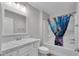 Bathroom with marble countertops, white vanity, and bathtub with shower at 3984 Kanawha Pl, The Villages, FL 32163