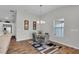 Bright dining area featuring a modern light fixture and stylish rug over wood-look floors at 3984 Kanawha Pl, The Villages, FL 32163