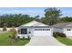 Charming single-story home boasts a well-manicured lawn, screened porch, and a two-car garage at 3984 Kanawha Pl, The Villages, FL 32163