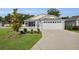 Charming single-story home boasts a well-manicured lawn and a two-car garage at 3984 Kanawha Pl, The Villages, FL 32163