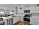 Kitchen with white cabinets, stainless steel appliances, and a breakfast bar at 3984 Kanawha Pl, The Villages, FL 32163