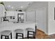 Kitchen with white cabinets, stainless steel appliances, and marble countertops, and breakfast bar at 3984 Kanawha Pl, The Villages, FL 32163