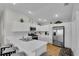 Bright kitchen with white cabinets, stainless steel appliances, and marble countertops at 3984 Kanawha Pl, The Villages, FL 32163
