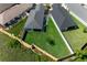 Aerial view of a home with a large backyard, patio, and privacy fence in a residential neighborhood at 4451 Elijah Loop, The Villages, FL 32163