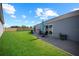 Spacious backyard featuring a patio, lush green lawn, and a view of the rear of the home at 4451 Elijah Loop, The Villages, FL 32163