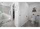 Bright bathroom area showcasing a stylish toilet and walk-in shower with modern gray tiling at 4451 Elijah Loop, The Villages, FL 32163