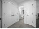 Hallway view of a bathroom with tile flooring and neutral colored walls at 4451 Elijah Loop, The Villages, FL 32163