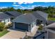 Charming single Gathering home featuring manicured front yard and a two-car garage at 4451 Elijah Loop, The Villages, FL 32163