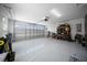 Clean and spacious garage featuring an automatic door opener, durable epoxy floors, and ample storage racks at 4451 Elijah Loop, The Villages, FL 32163