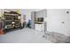 Garage featuring custom storage cabinets, workstation, and well-organized shelving, perfect for hobbies and projects at 4451 Elijah Loop, The Villages, FL 32163