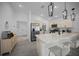 Open-concept kitchen features stainless appliances, a spacious island with seating, and a pantry at 4451 Elijah Loop, The Villages, FL 32163