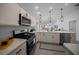 This open-concept kitchen offers stainless appliances and a view into the living room and dining areas at 4451 Elijah Loop, The Villages, FL 32163