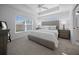 The spacious main bedroom has a large window for natural light and a tray ceiling with fan at 4451 Elijah Loop, The Villages, FL 32163