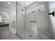 Detailed view of a walk-in shower with a bench, window, and gray subway tile surround at 4451 Elijah Loop, The Villages, FL 32163