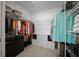 Organized walk-in closet featuring ample shelving, hanging space, and a built-in storage unit at 4451 Elijah Loop, The Villages, FL 32163