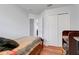 Bedroom with natural light, closet, and wood-look flooring at 4649 College Dr, Orlando, FL 32811