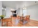 Bright dining area featuring hardwood floors, a chandelier, and natural light from the window at 4649 College Dr, Orlando, FL 32811