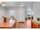 Inviting dining area with wood floors and a white door leading to a comfortable living space at 4649 College Dr, Orlando, FL 32811